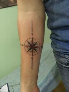 Dark Ink Compass Tattoo On Arm by Andy Blanco