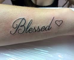 Black background blessed tattoo on forearm for men